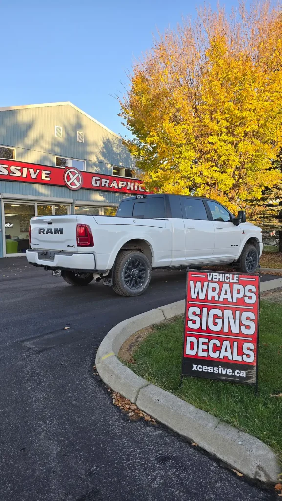White truck showcasing chrome delete near vehicle wraps and decals signage