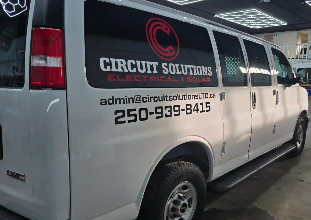 Custom stickers Okotoks on a white van promoting an electrical solutions company