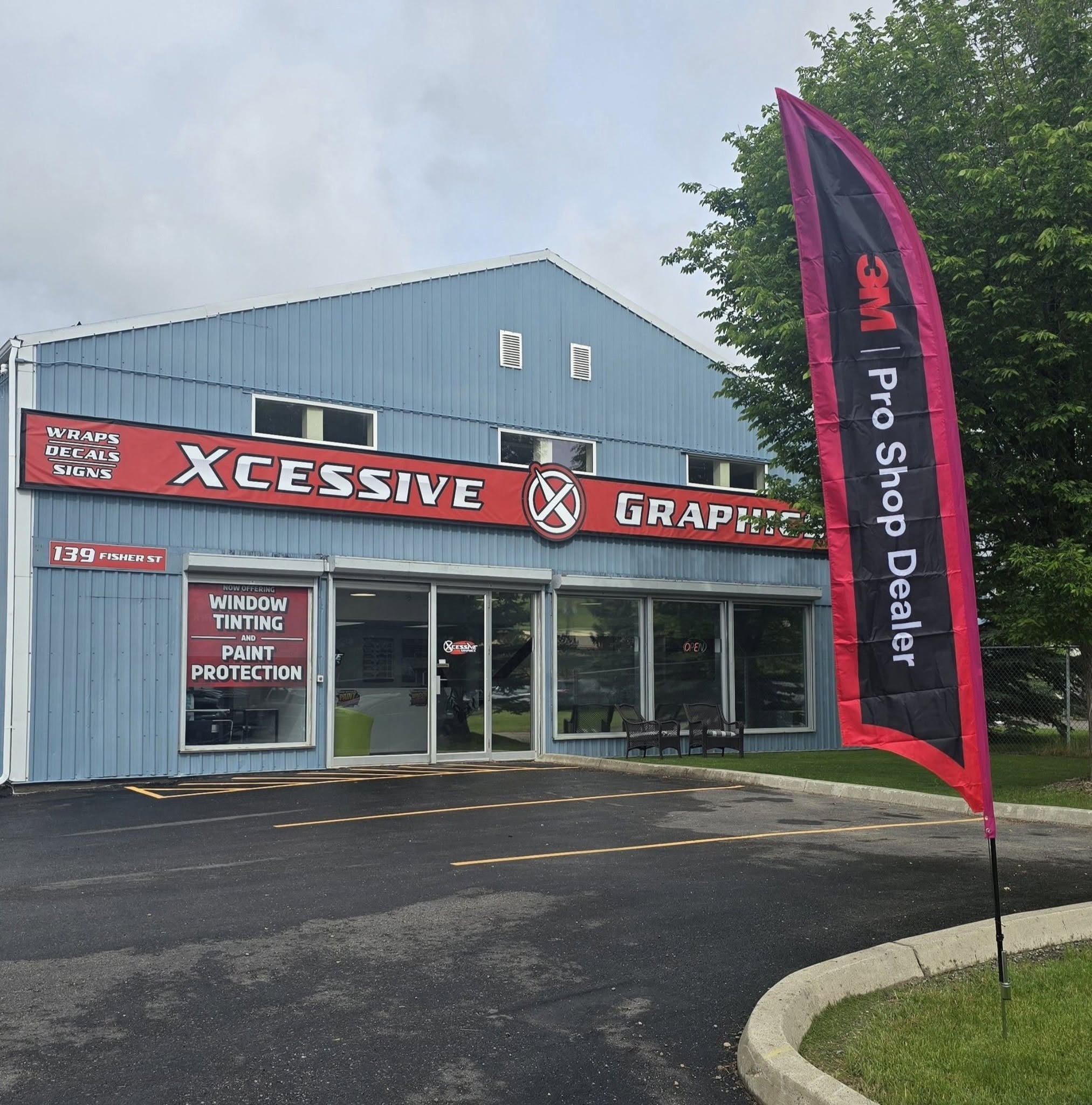 About us signage prominently displayed on a storefront with a large flag